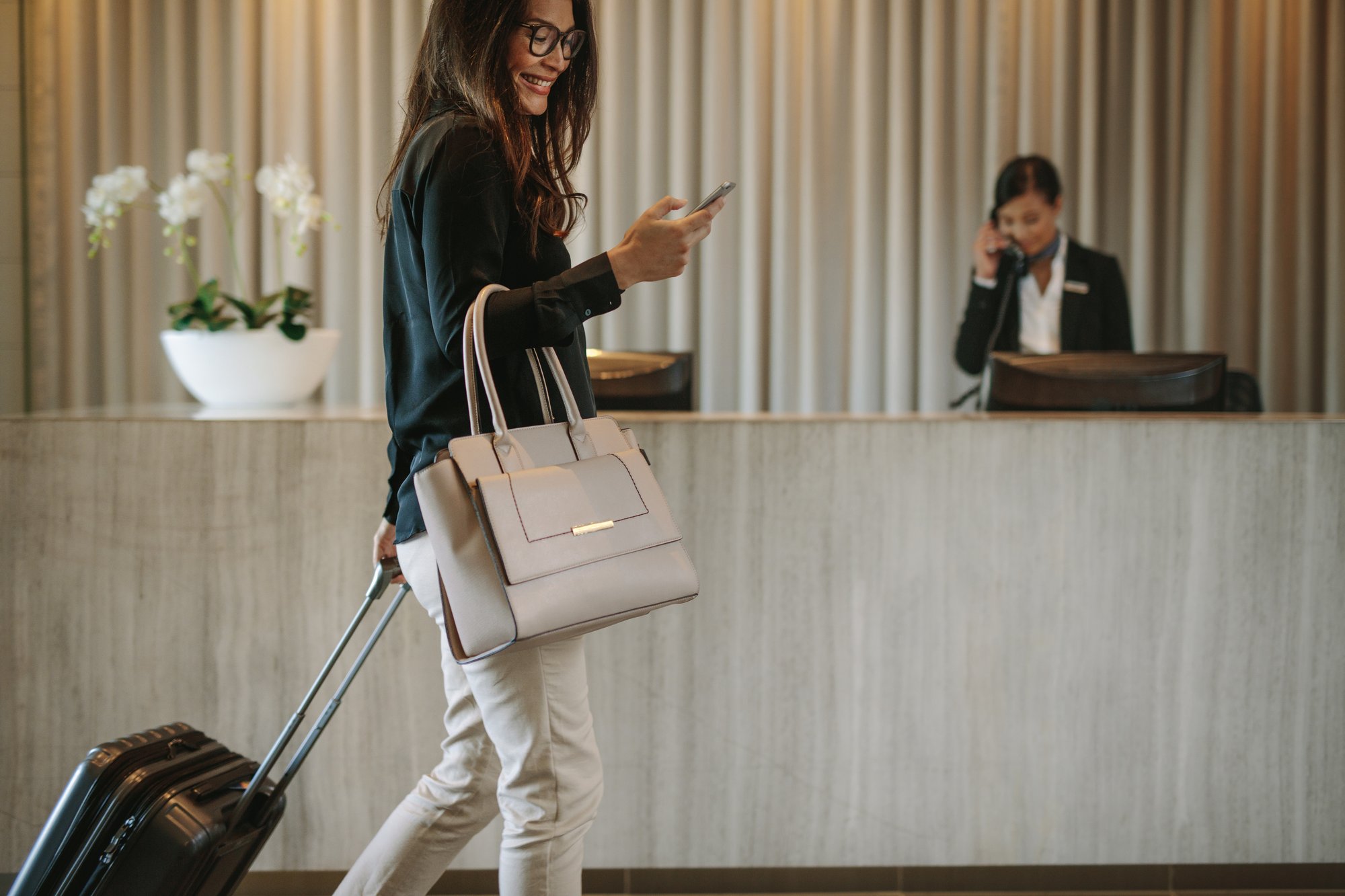 woman walks through hotel lobby